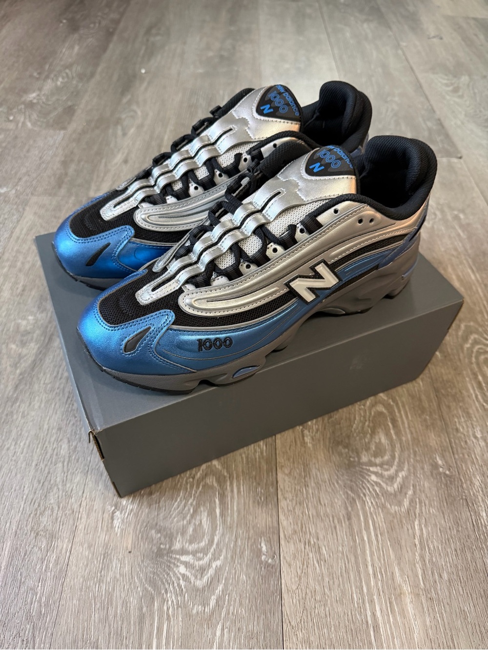New Balance Men’s 1000 Metallic Blue & Silver Sneakers - Picture 1 of 8
